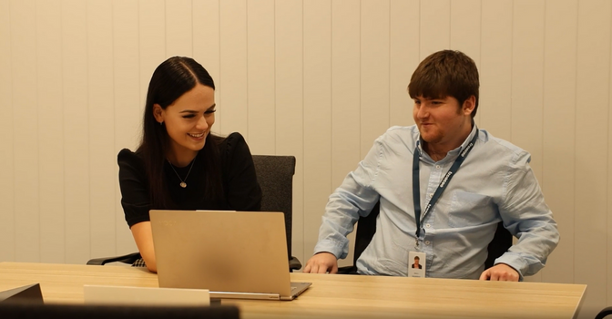 Mikey and his manager Vanessa working on a laptop